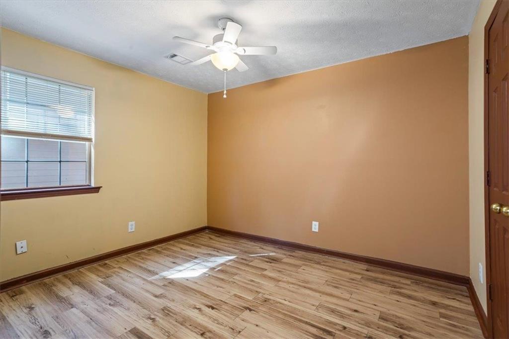 150 Crystal Brook Griffin, GA 30223 - Photo 12 of 28 a view of empty room with wooden floor and fan