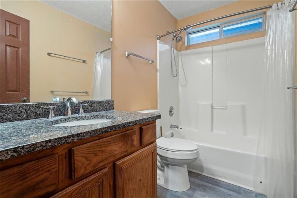 150 Crystal Brook Griffin, GA 30223 - Photo 14 of 28 a bathroom with a granite countertop sink toilet and shower