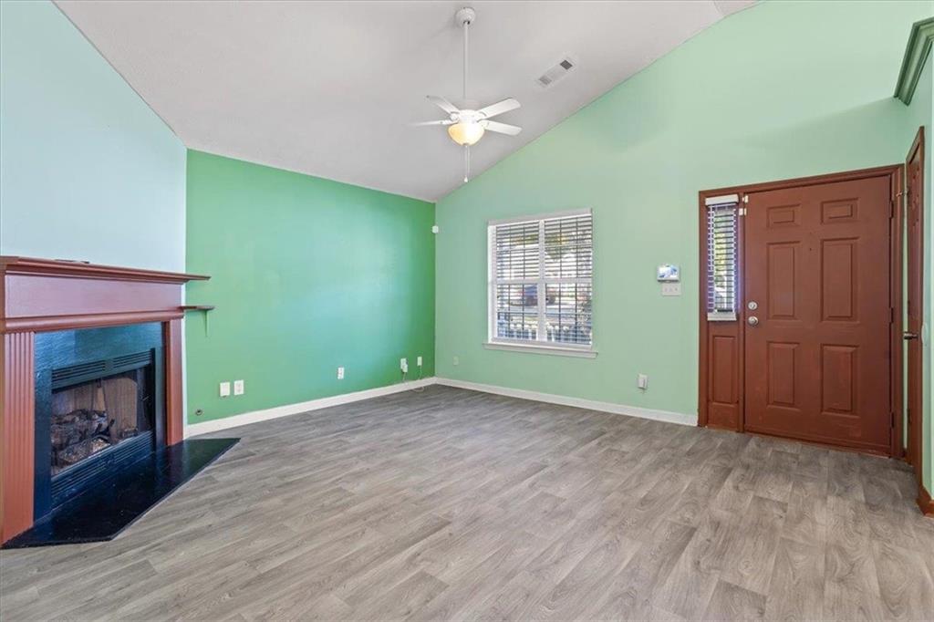 150 Crystal Brook Griffin, GA 30223 - Photo 4 of 28 a view of an empty room with a fireplace and a window