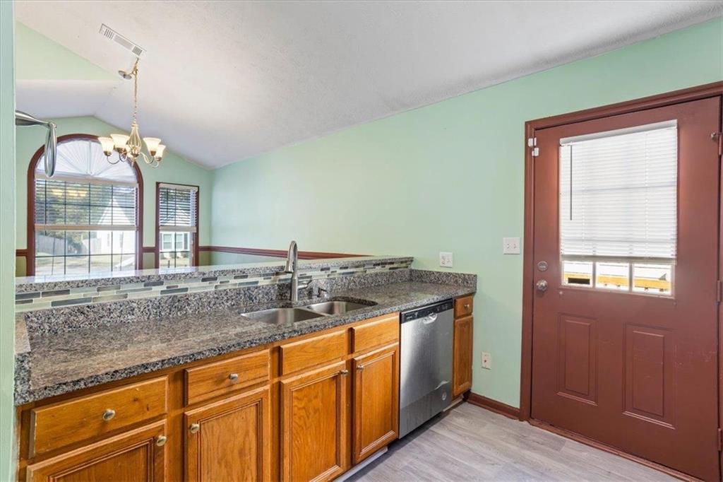 150 Crystal Brook Griffin, GA 30223 - Photo 9 of 28 a bathroom with a granite countertop sink and a large mirror