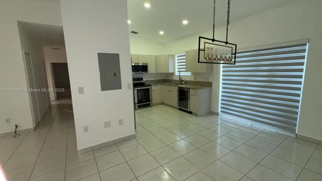 a kitchen with a refrigerator and a sink