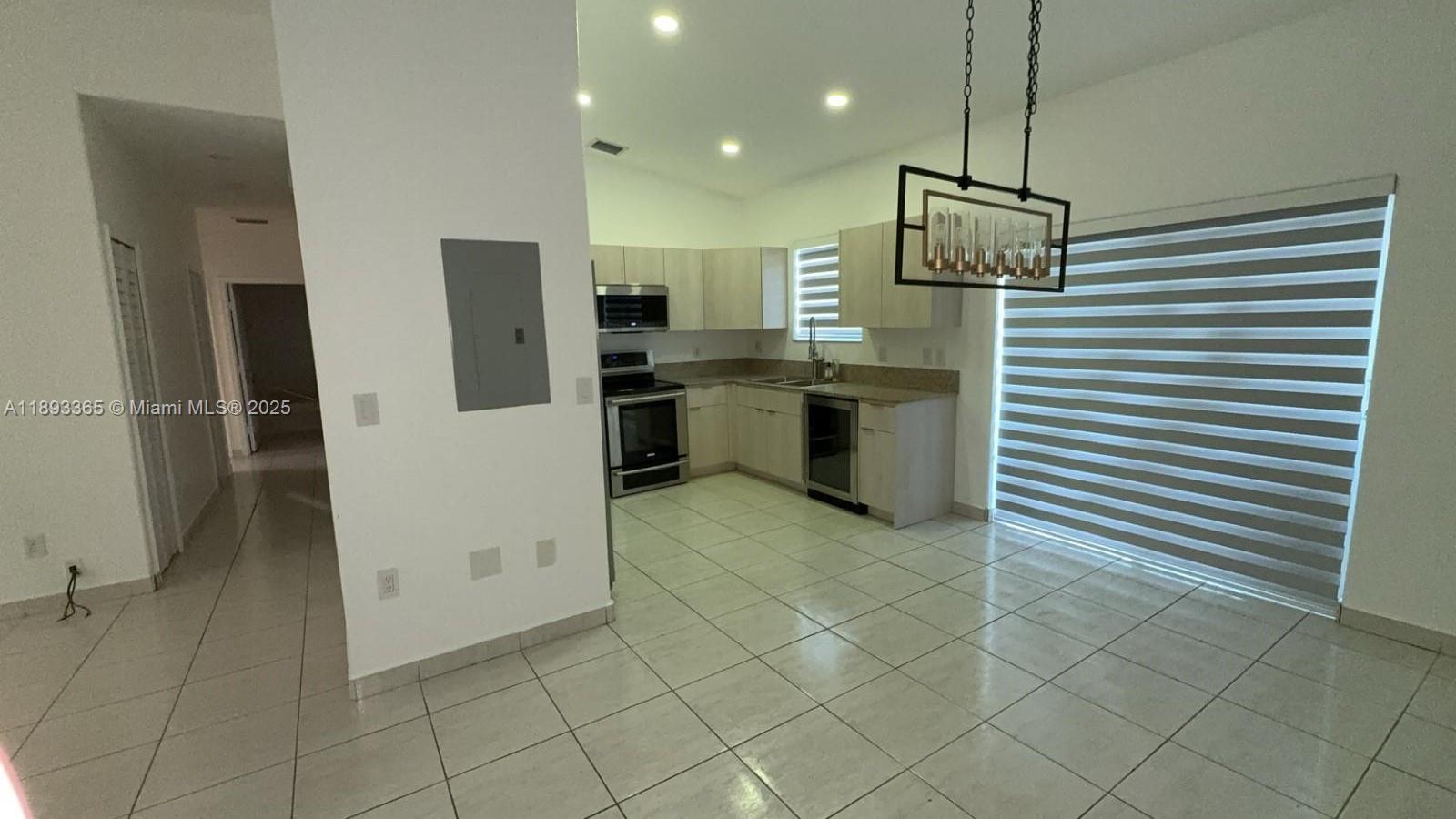7221 Northwest 174th Terrace, Unit 202 Hialeah, FL 33015 - Photo 3 of 15 a kitchen with a refrigerator and a sink