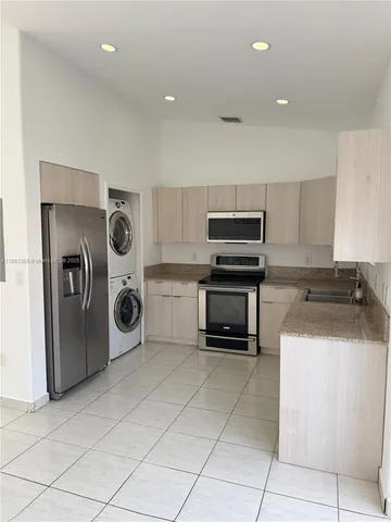 a kitchen with a stove top oven and cabinets