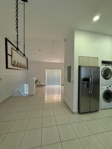a view of a storage & utility room with two washing machine