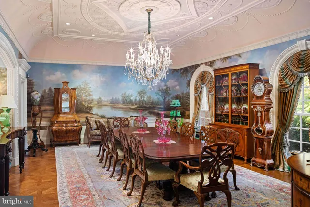 a living room with fireplace furniture and a chandelier