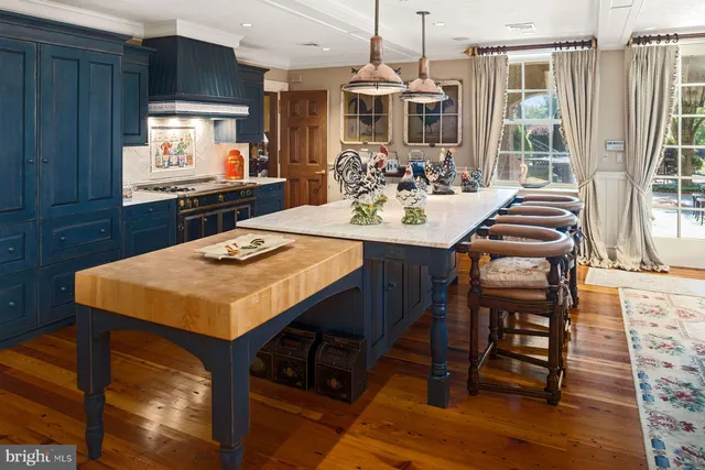 a kitchen with stainless steel appliances wooden cabinets and a table