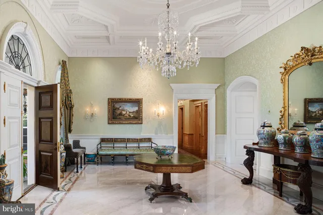 a living room with furniture chandelier and a chandelier
