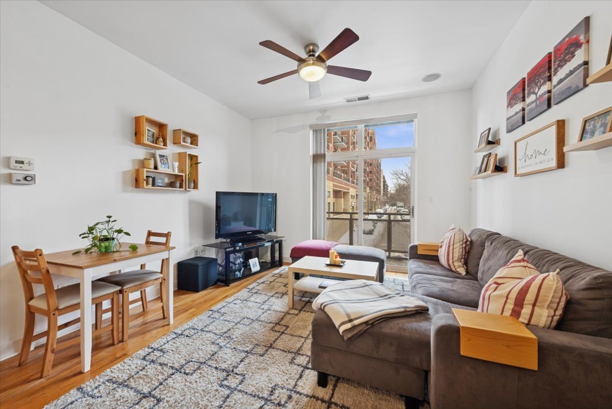 1515 South Halsted Street, Unit 204 Chicago, IL 60607 - Photo 5 of 14 a living room with furniture and a flat screen tv
