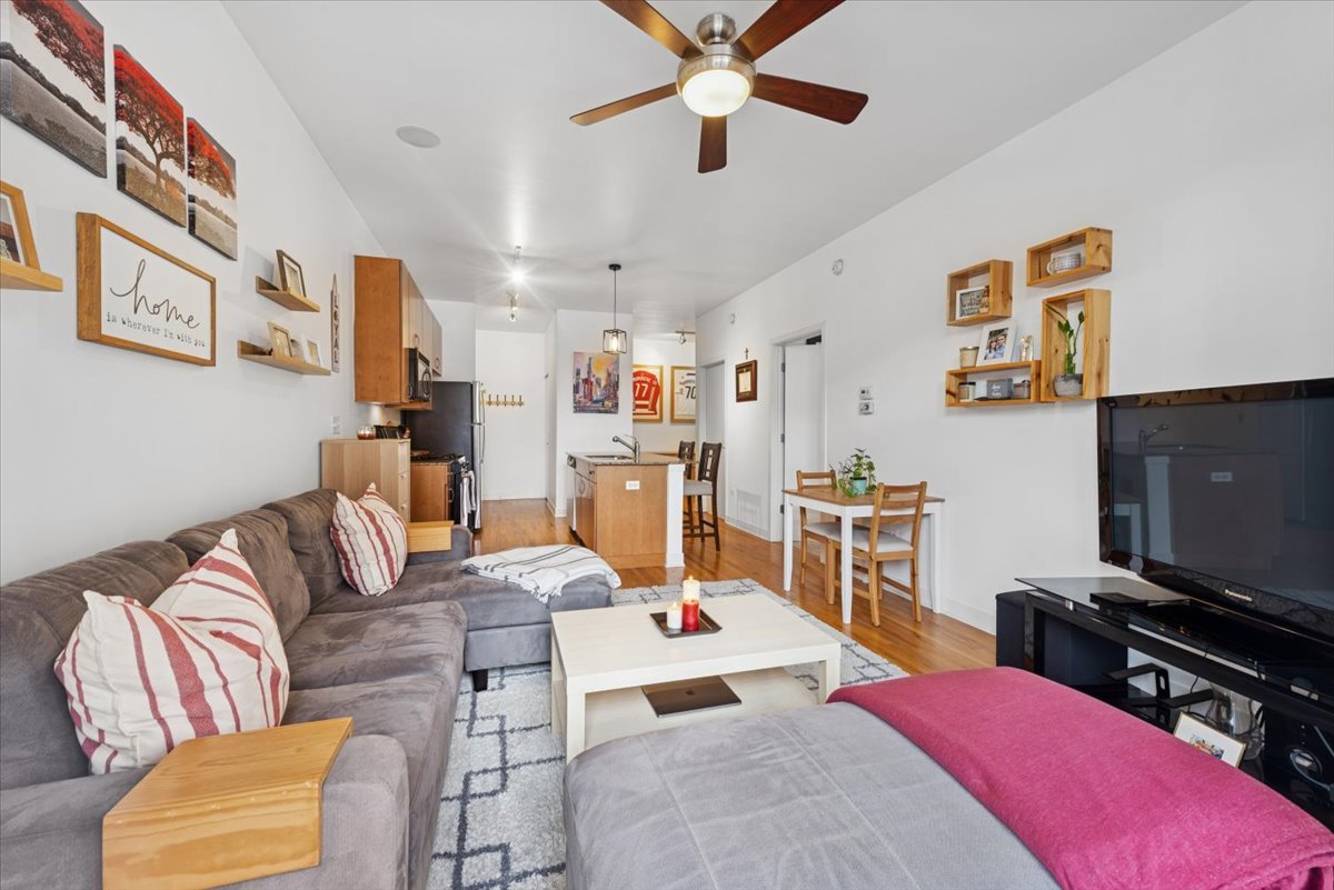 1515 South Halsted Street, Unit 204 Chicago, IL 60607 - Photo 6 of 14 a living room with furniture and a flat screen tv
