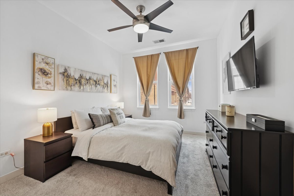 1515 South Halsted Street, Unit 204 Chicago, IL 60607 - Photo 9 of 14 a bedroom with a bed and a flat screen tv