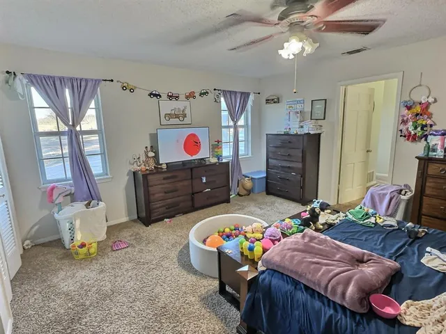 a bedroom with furniture and a baby crib