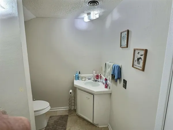 a bathroom with a sink toilet and a mirror