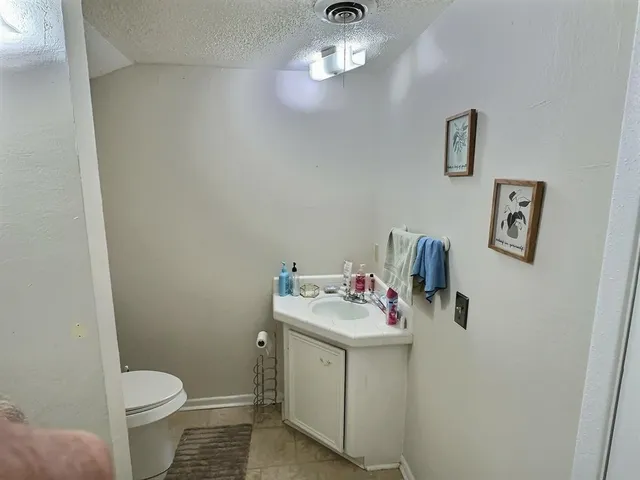 a bathroom with a sink toilet and a mirror