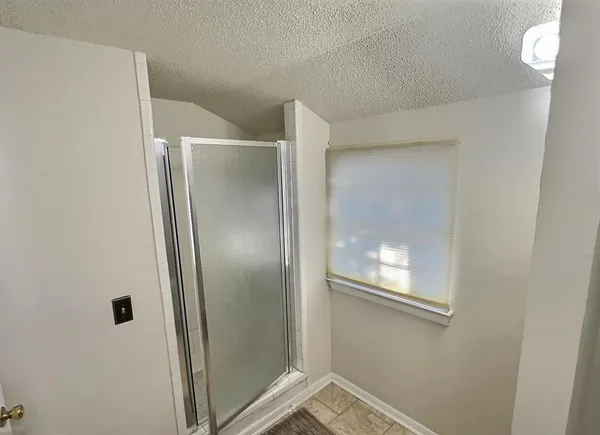 a bathroom with a glass shower door