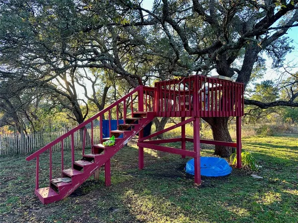 a view of a park with iron fence
