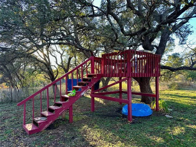 a view of a park with iron fence