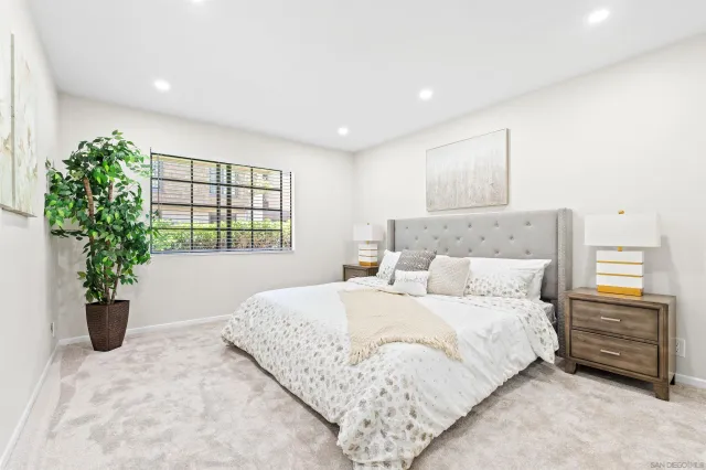 a bedroom with a bed and a potted plant