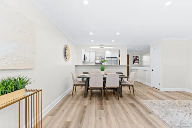 a dining room with furniture and wooden floor