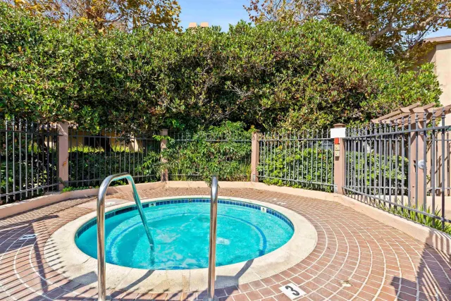a view of a swimming pool with a patio and a garden