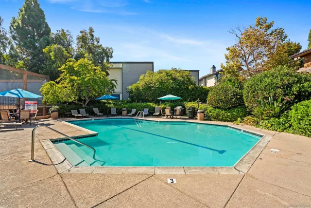 a view of swimming pool with outdoor seating and plants