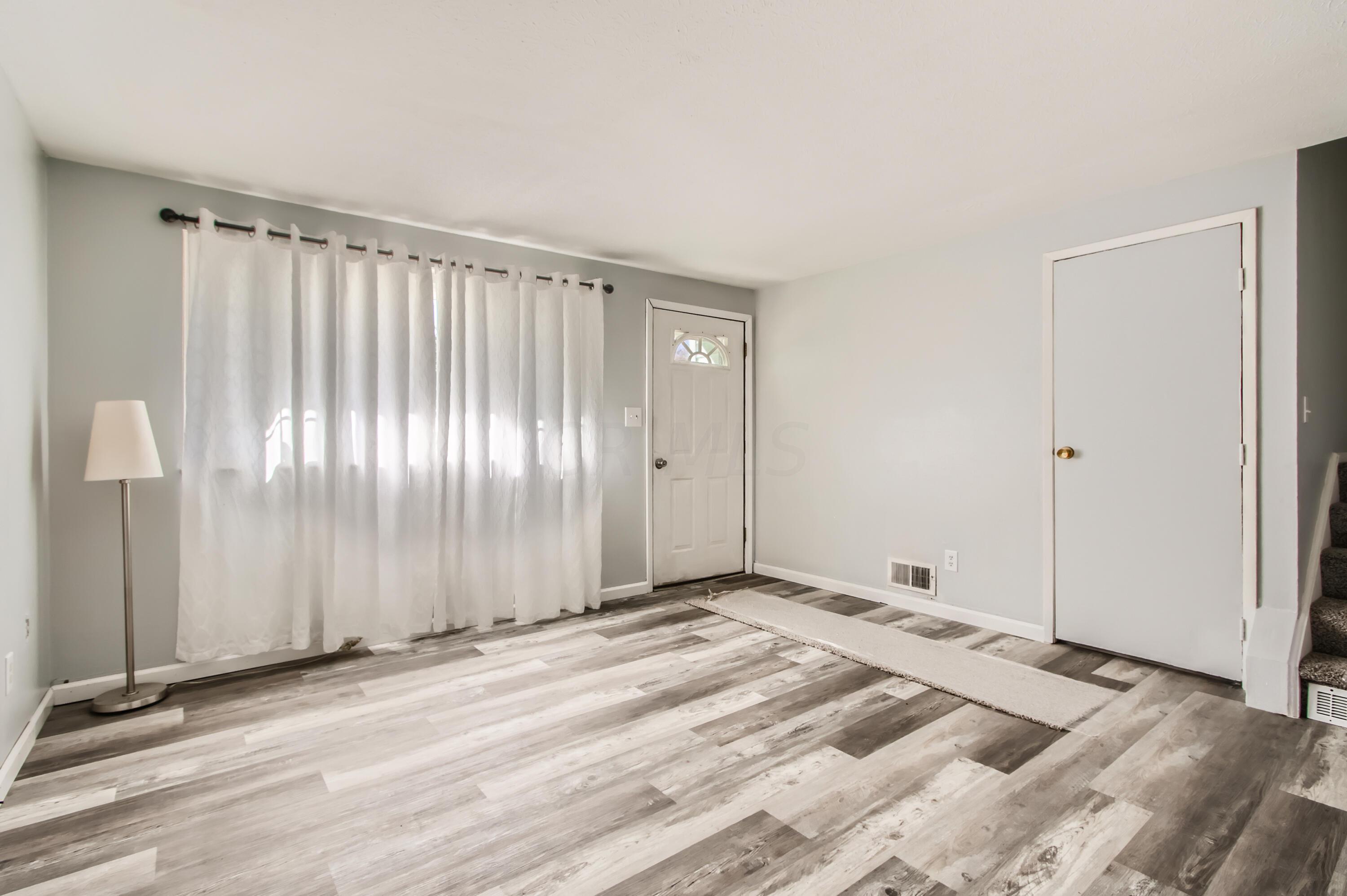 Living room is approx. 13.6 x 13.4 with new luxury vinyl flooring(LVP)
