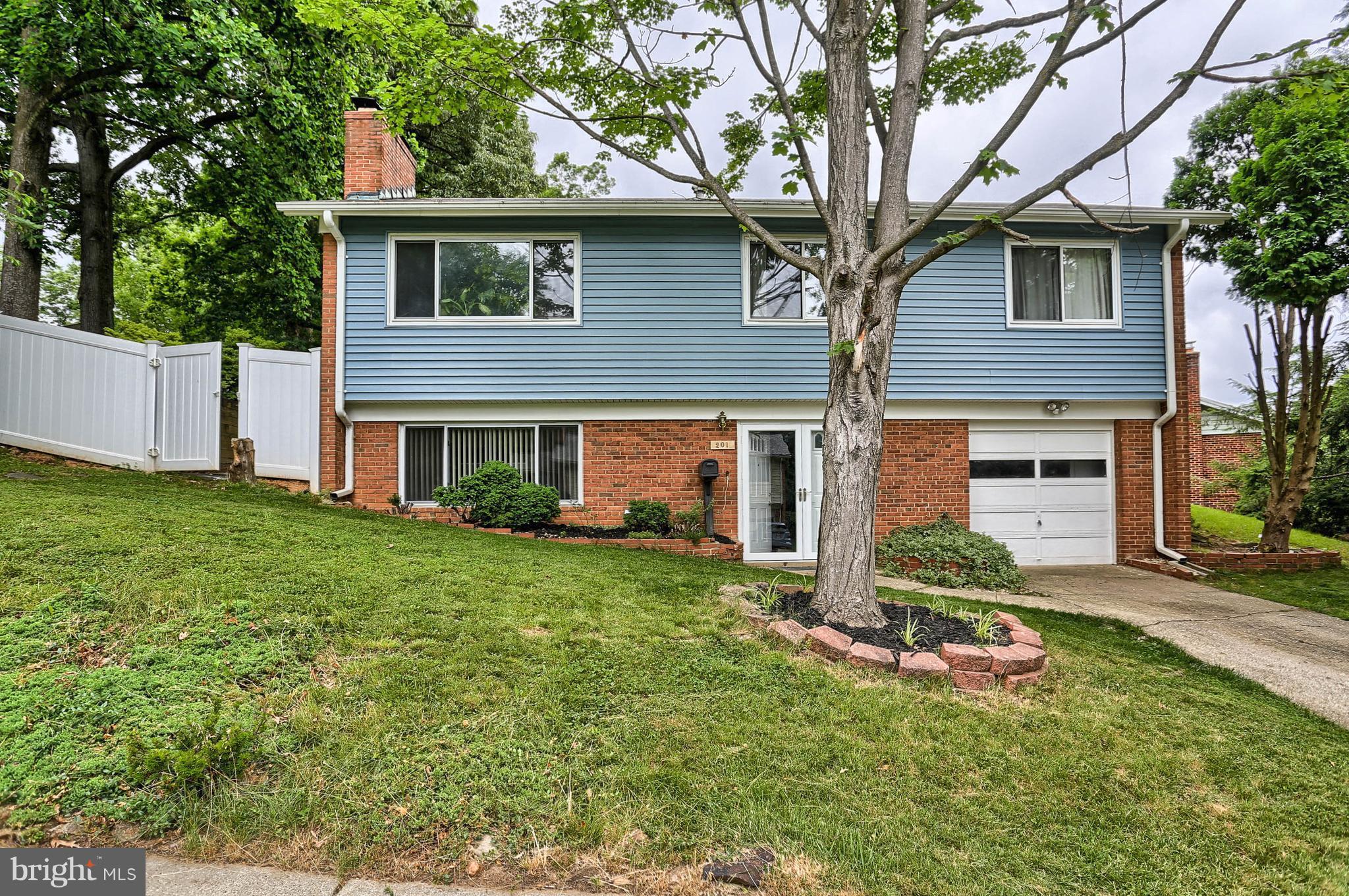 201 Belton Road Silver Spring, MD 20901 - Photo 2 of 24 a front view of a house with a yard and garage