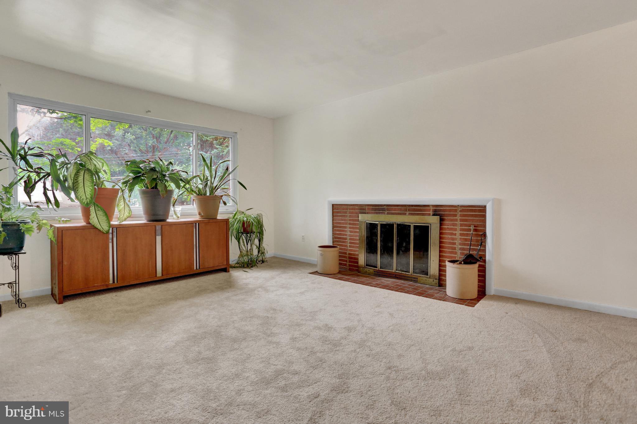 201 Belton Road Silver Spring, MD 20901 - Photo 16 of 24 a view of an empty room with a fireplace and a large window