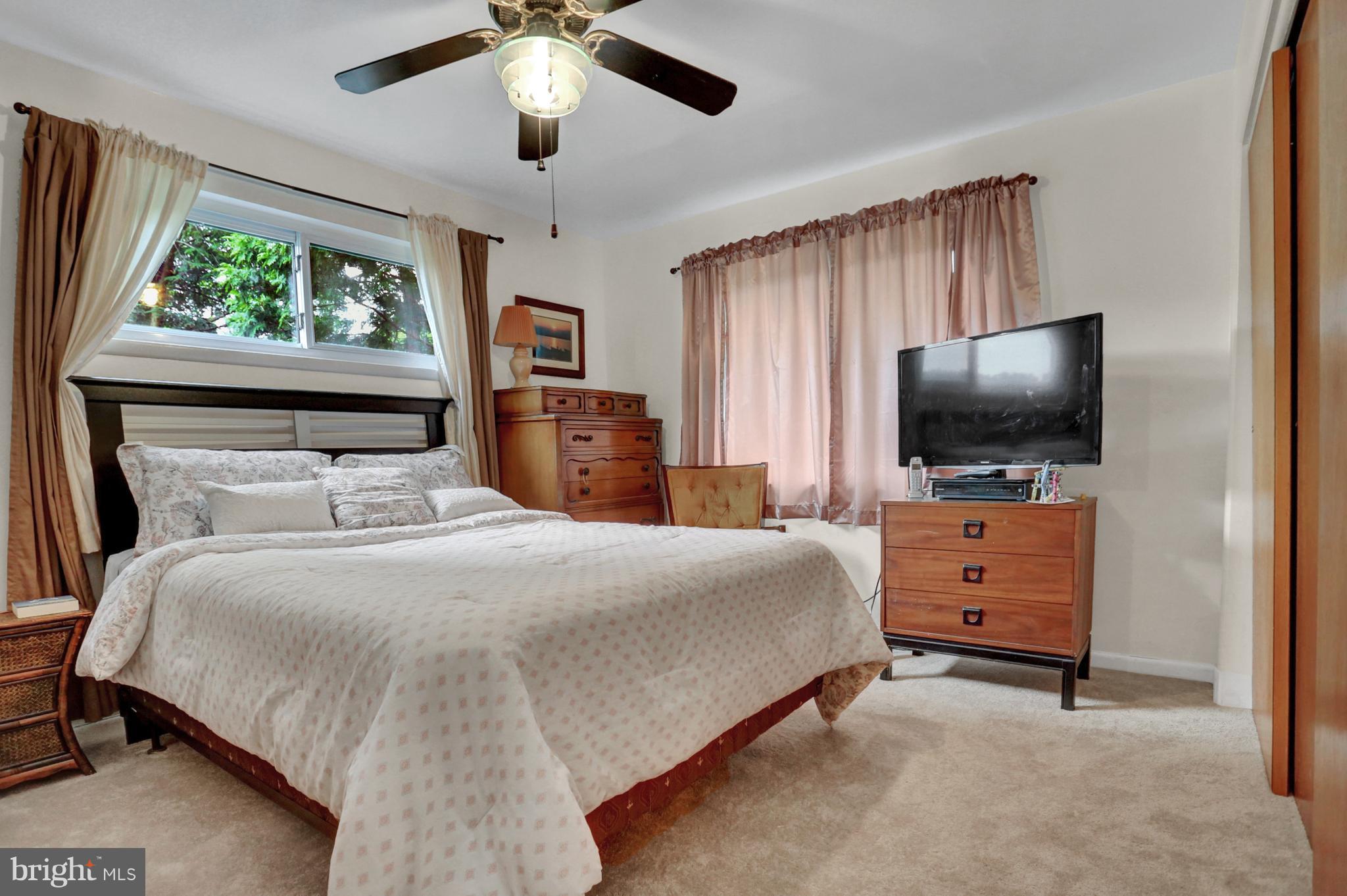 201 Belton Road Silver Spring, MD 20901 - Photo 5 of 24 a bedroom with a bed and flat screen tv