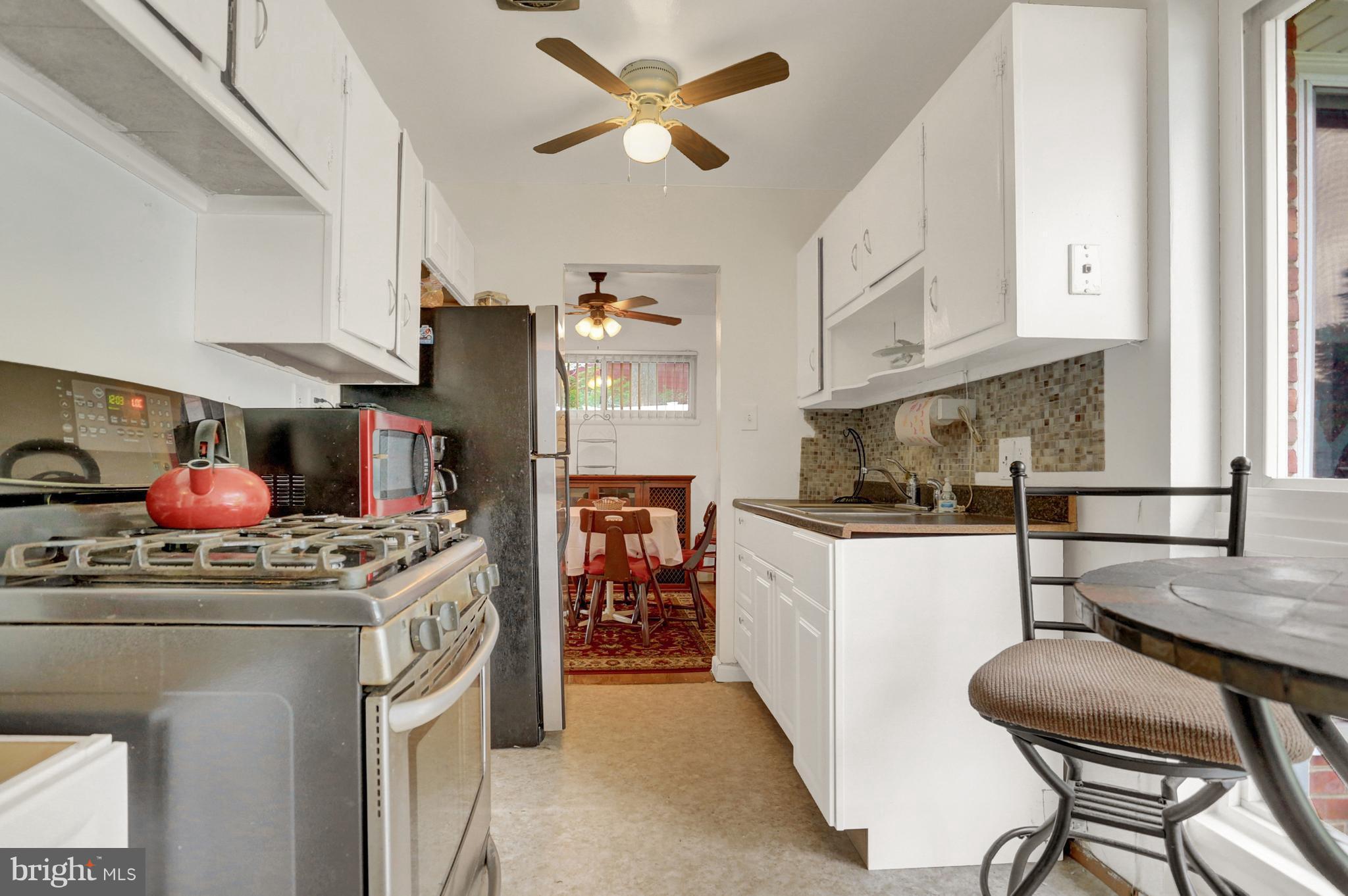 201 Belton Road Silver Spring, MD 20901 - Photo 6 of 24 a kitchen with stainless steel appliances granite countertop a sink stove and cabinets