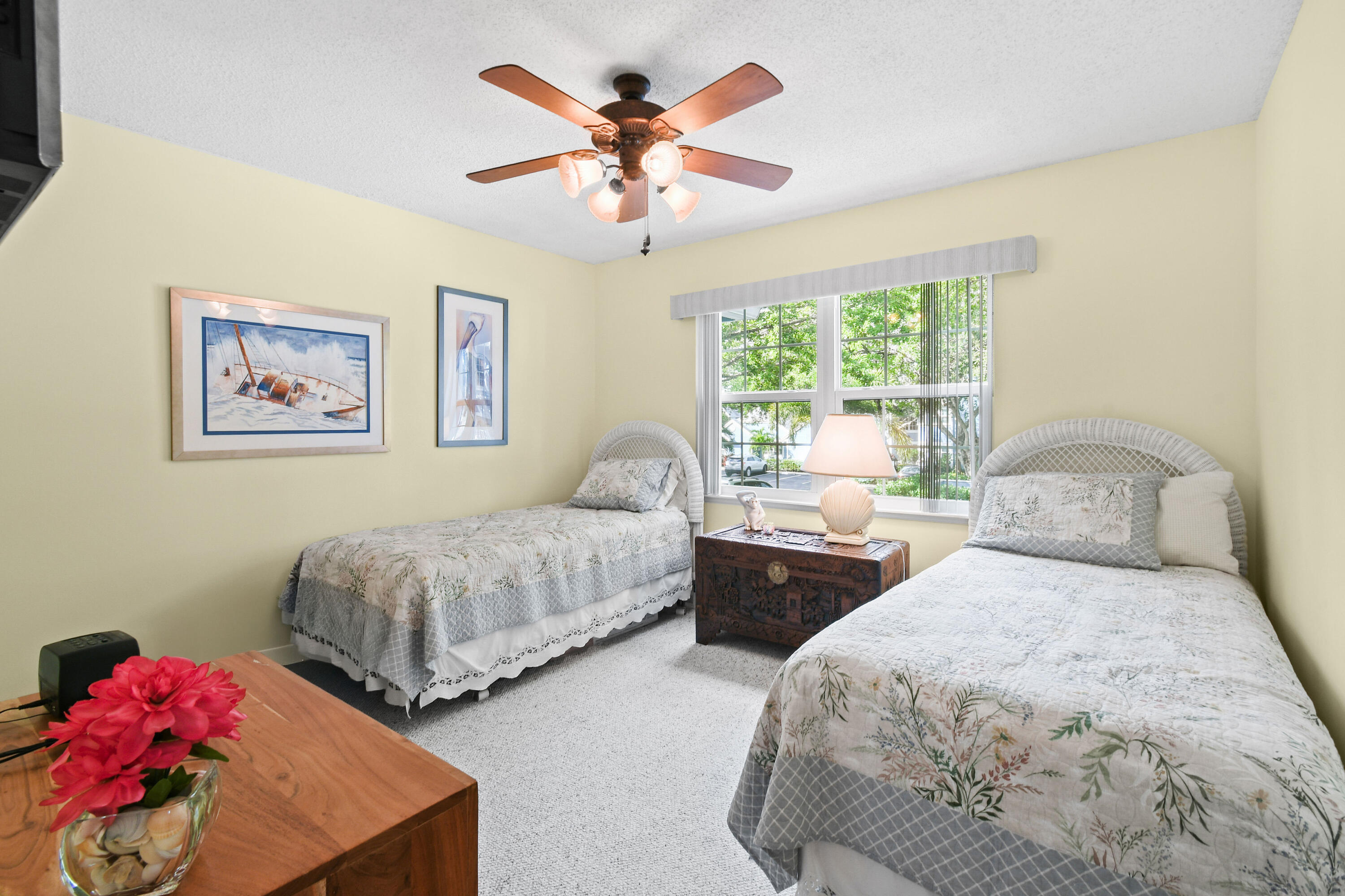 607 Ocean Dunes Circle Jupiter, FL 33477 - Photo 19 of 45 a bedroom with two beds and a chandelier