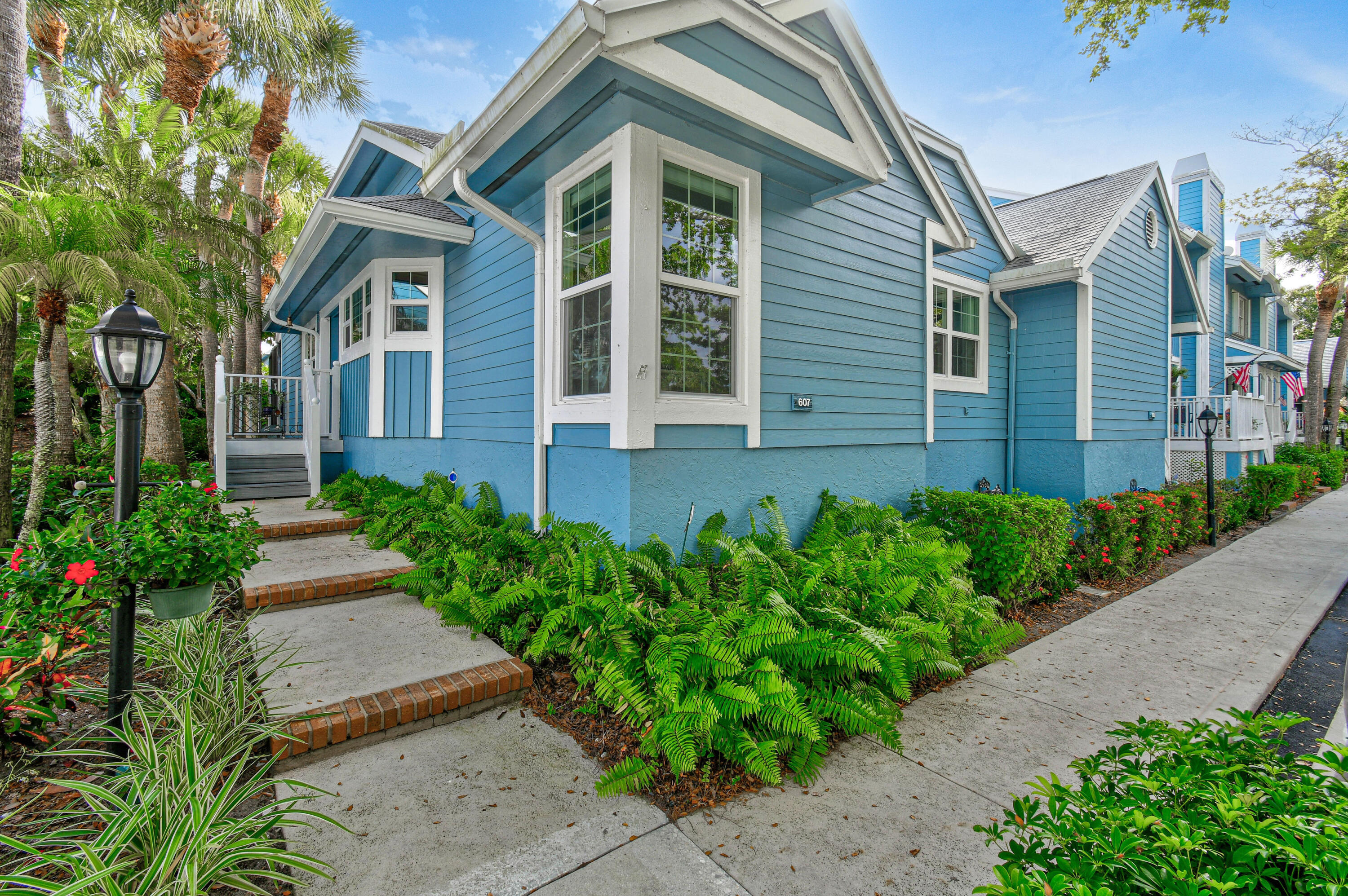607 Ocean Dunes Circle Jupiter, FL 33477 - Photo 2 of 45 a front view of a house with garden
