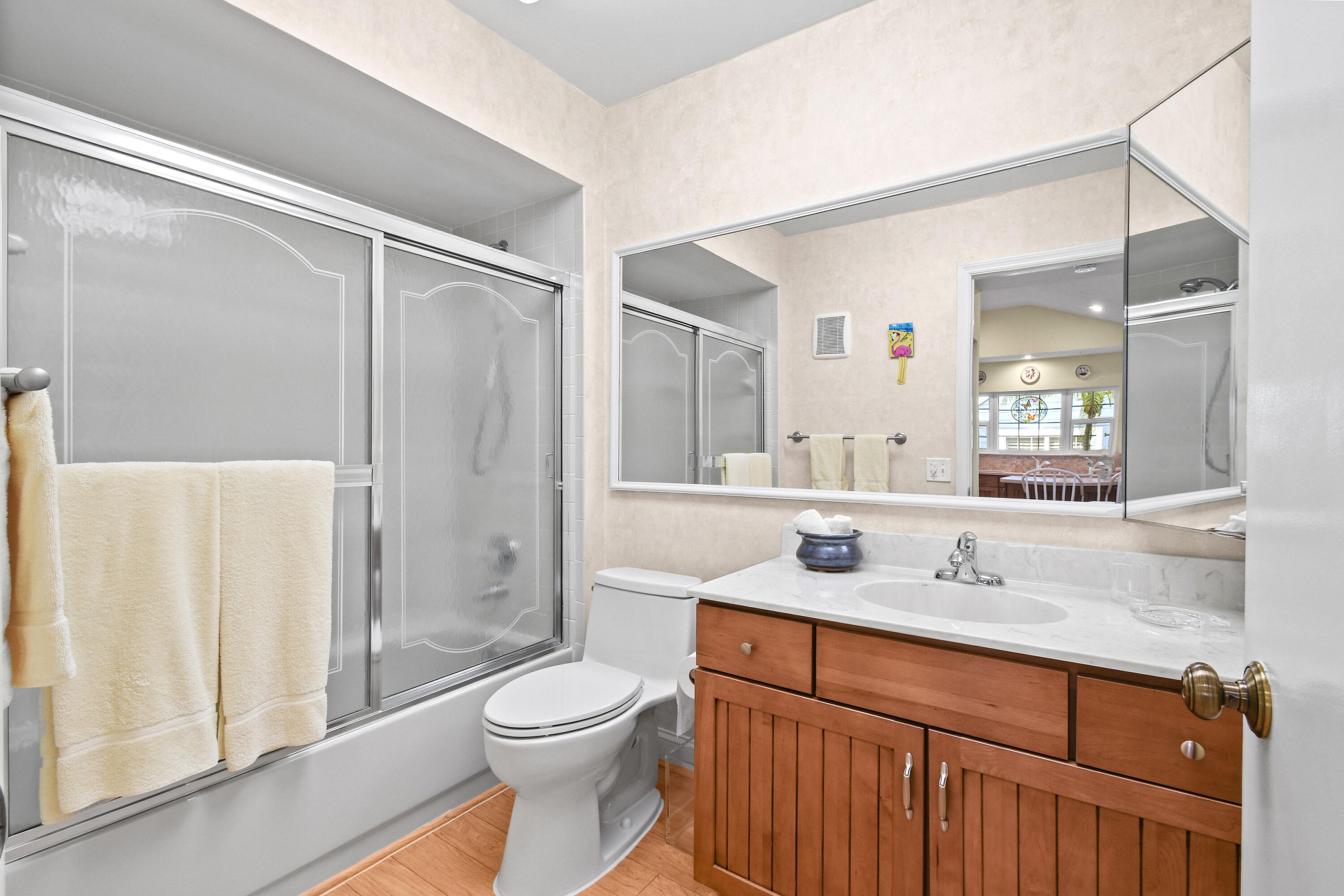 607 Ocean Dunes Circle Jupiter, FL 33477 - Photo 22 of 45 a bathroom with a granite countertop sink toilet and shower