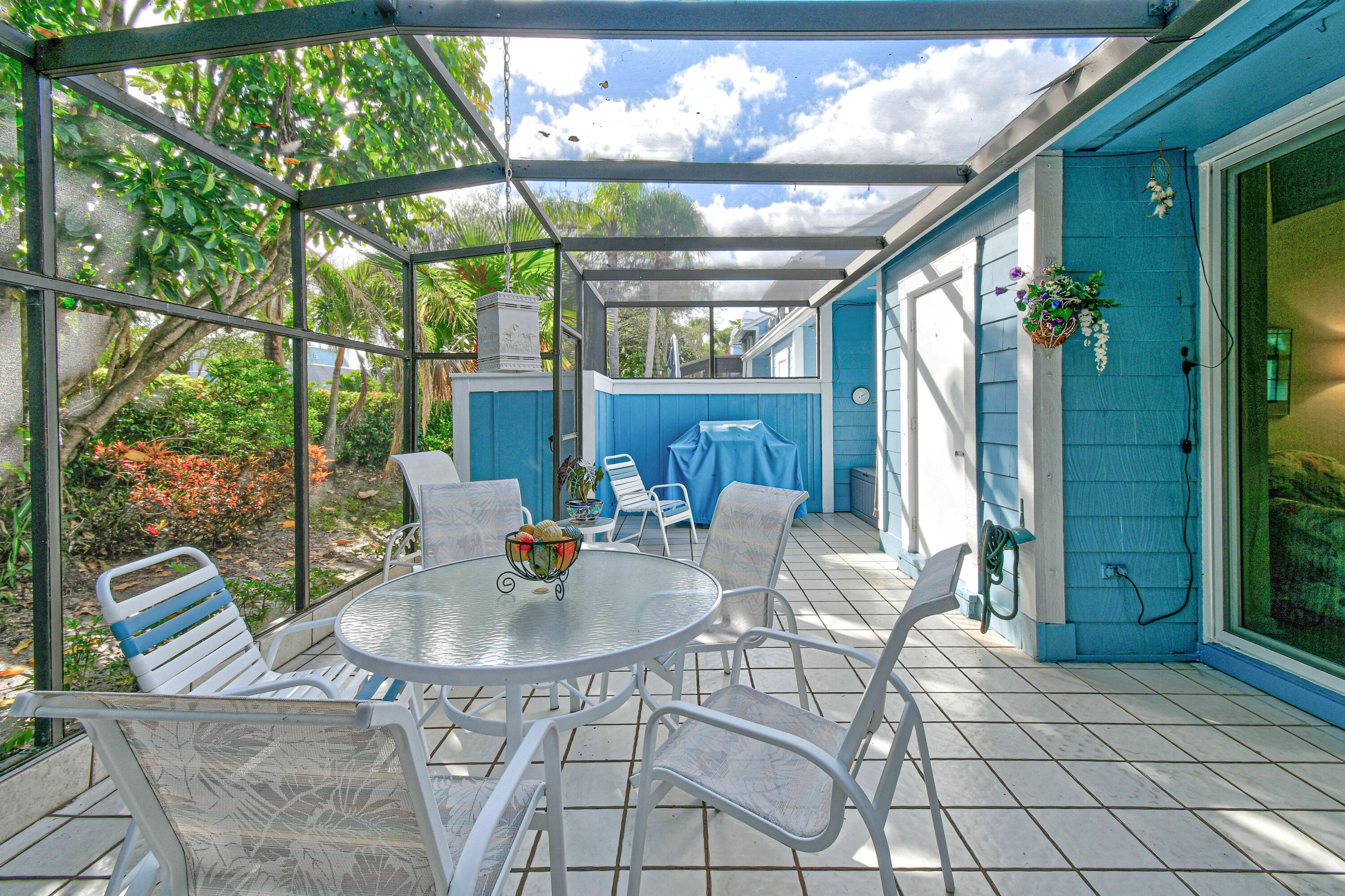607 Ocean Dunes Circle Jupiter, FL 33477 - Photo 25 of 45 a outdoor space with the couches and dining table with the garden view