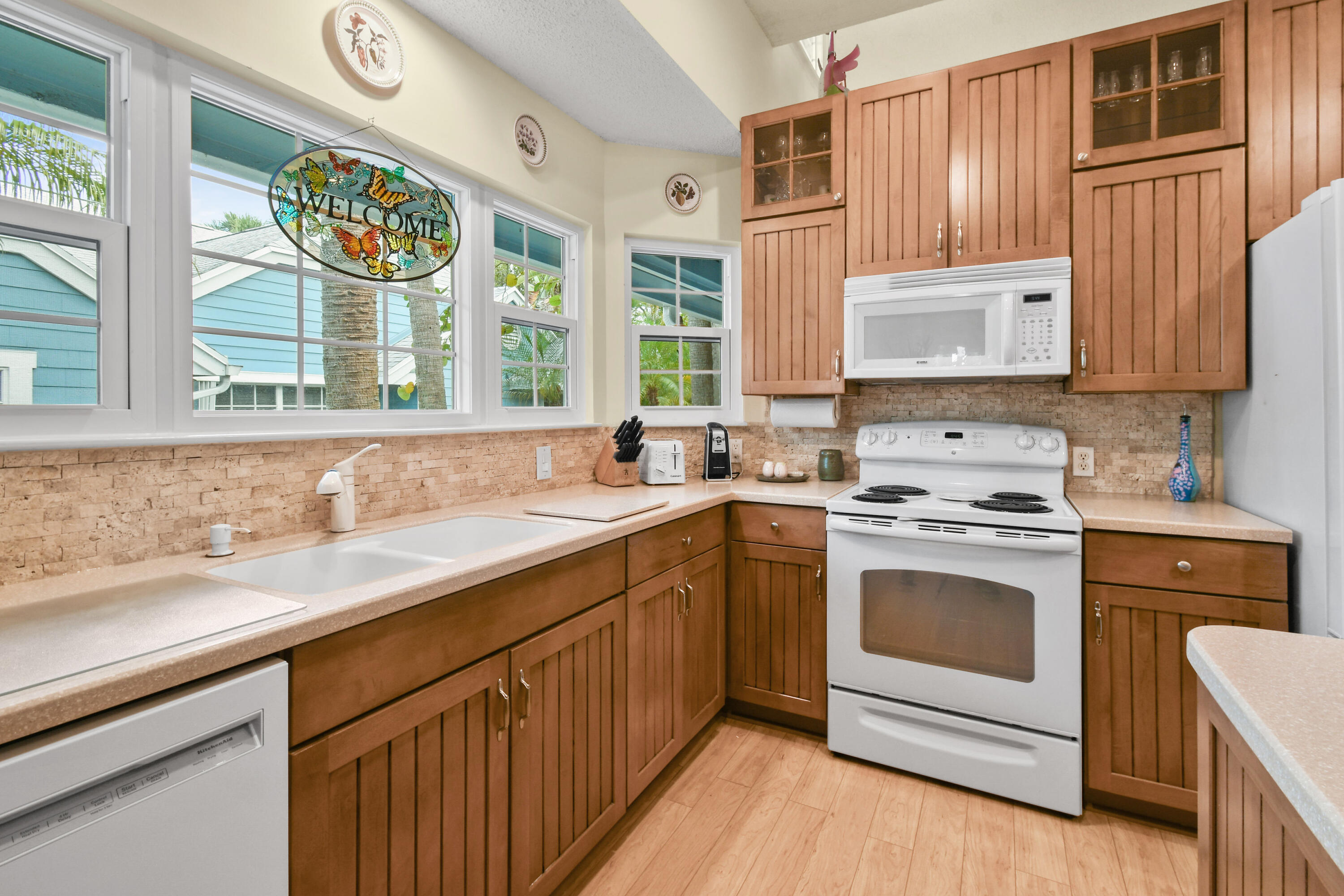 607 Ocean Dunes Circle Jupiter, FL 33477 - Photo 5 of 45 a kitchen with granite countertop a sink stove and cabinets