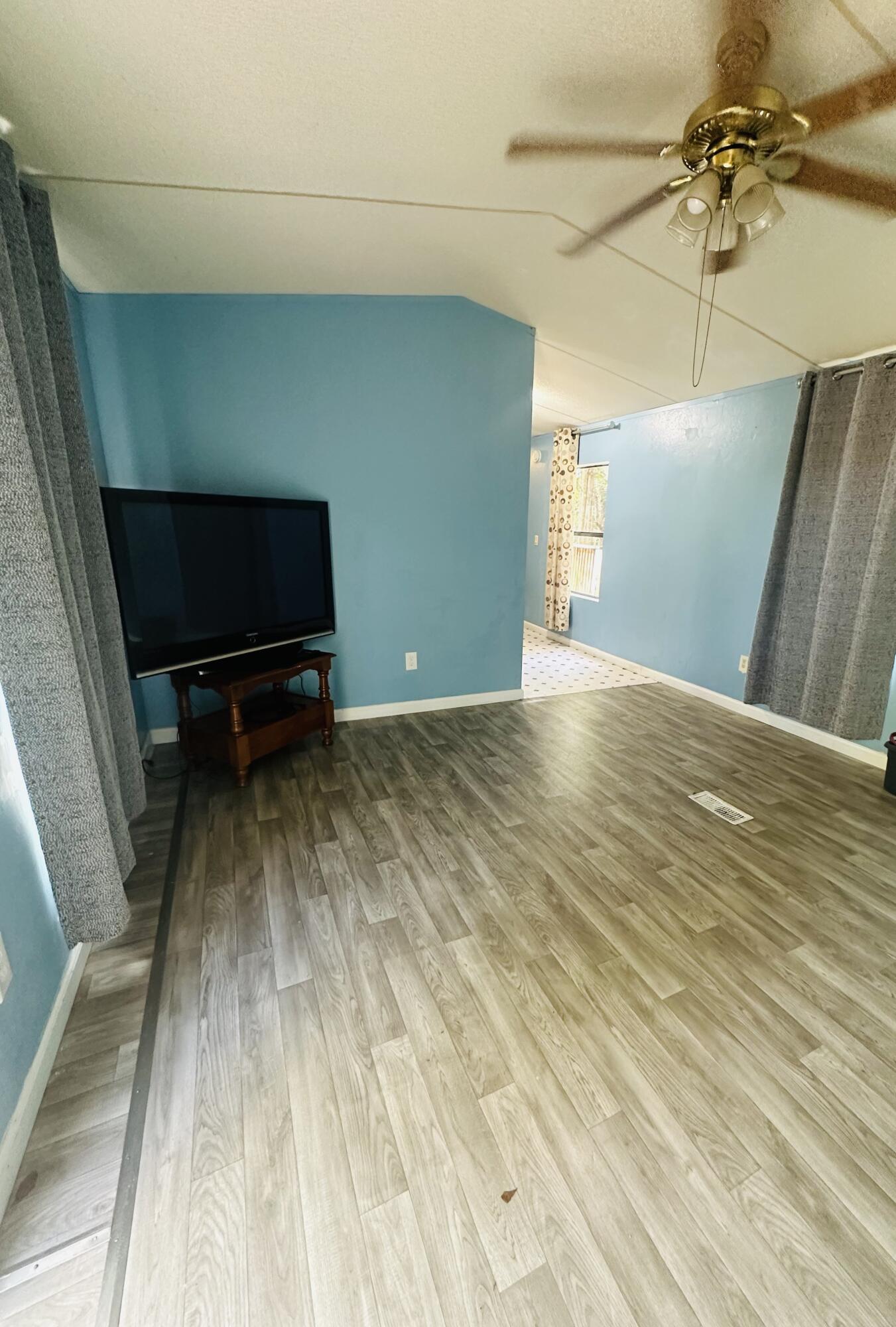 1980 Williams Ditch Road Cantonment, FL 32533 - Photo 3 of 18 a view of a room with a wooden floor and a ceiling fan
