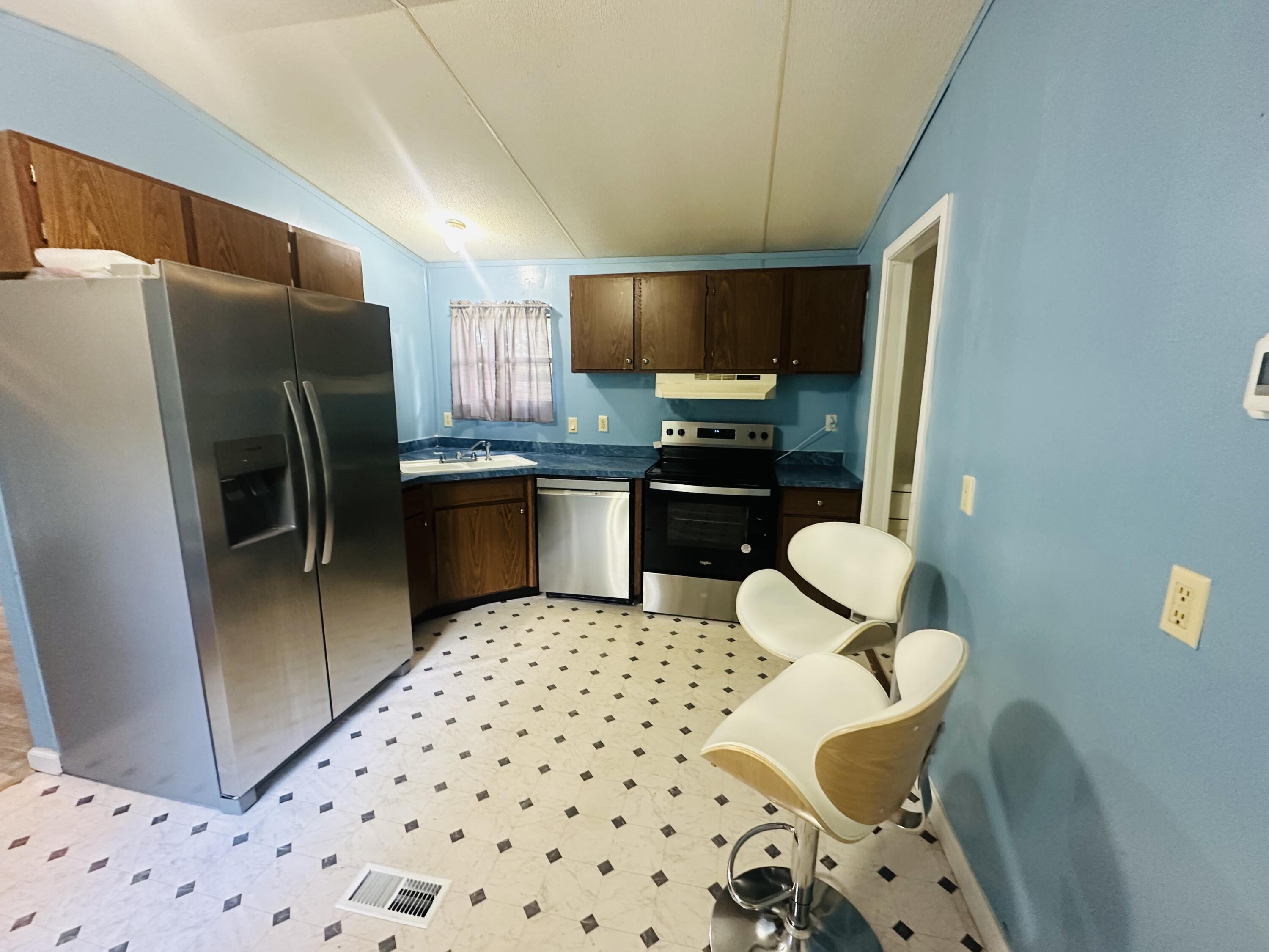 1980 Williams Ditch Road Cantonment, FL 32533 - Photo 4 of 18 a kitchen with stainless steel appliances a refrigerator and a sink