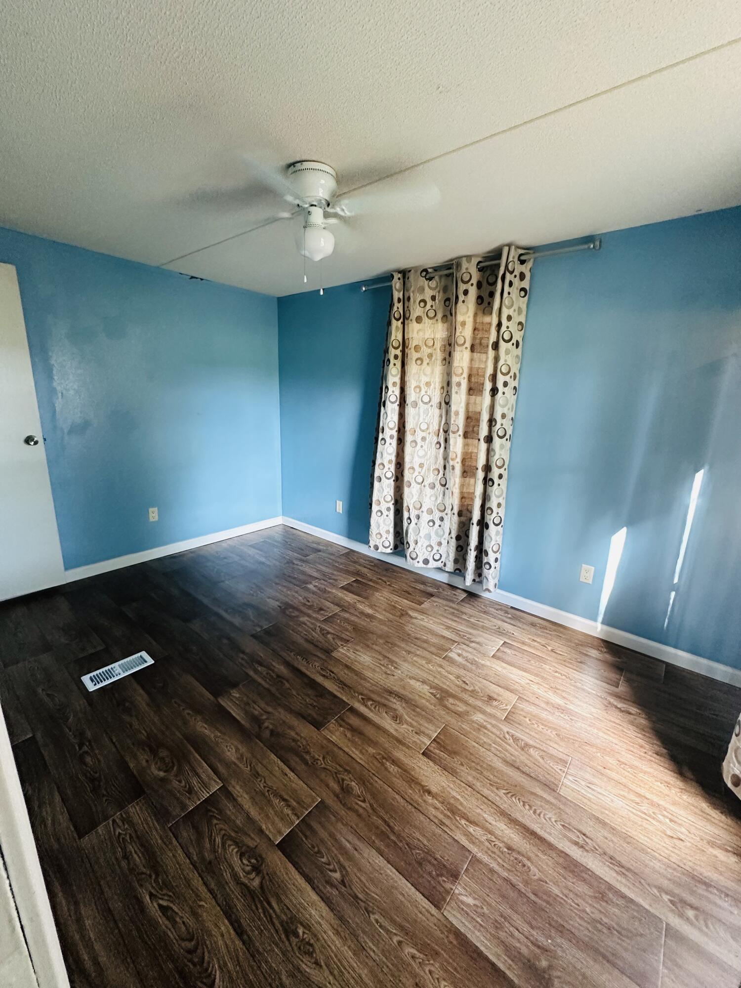 1980 Williams Ditch Road Cantonment, FL 32533 - Photo 6 of 18 a view of an empty room with wooden floor and a window