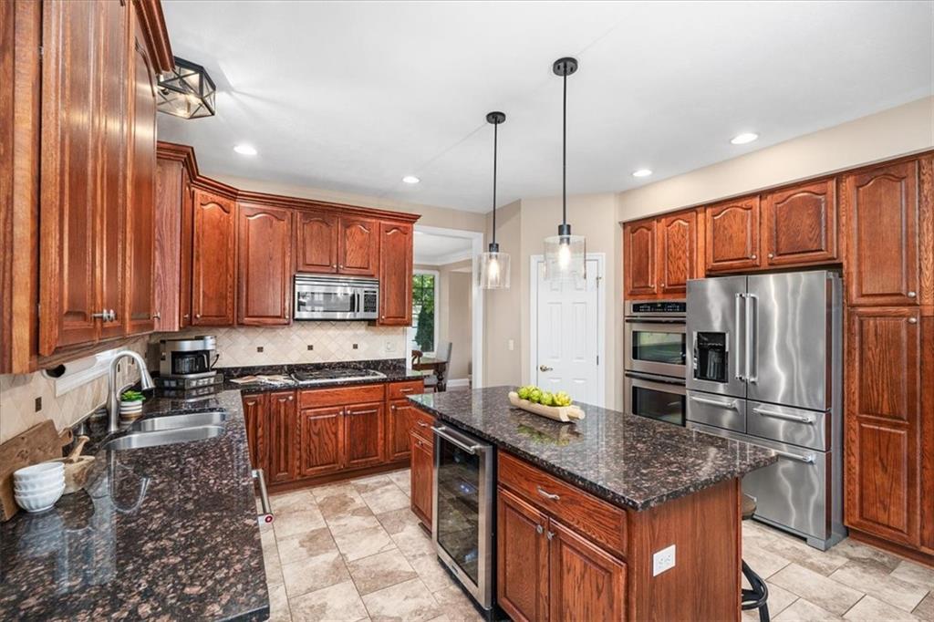 185 Pinkerton Road Wexford, PA 15090 - Photo 12 of 40 a kitchen with stainless steel appliances granite countertop a sink a stove and a refrigerator