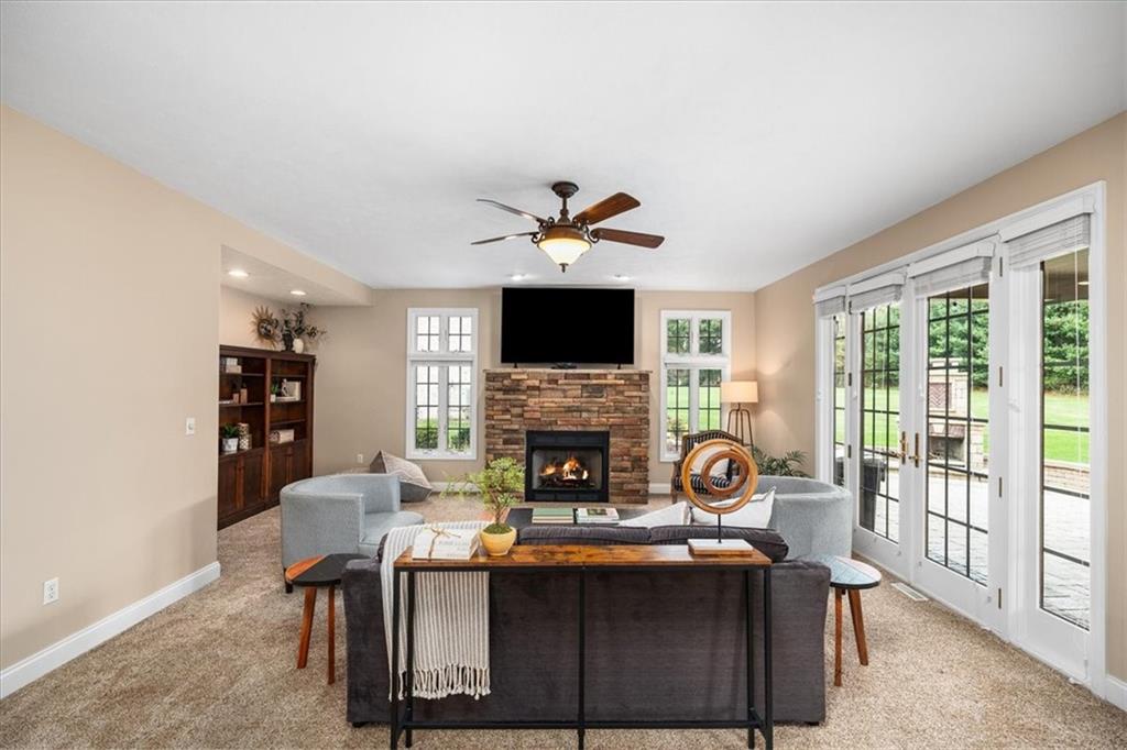 185 Pinkerton Road Wexford, PA 15090 - Photo 15 of 40 a living room with furniture a fireplace and a flat screen tv
