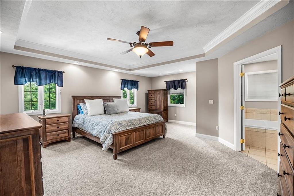 185 Pinkerton Road Wexford, PA 15090 - Photo 18 of 40 a spacious bedroom with a bed and a chandelier