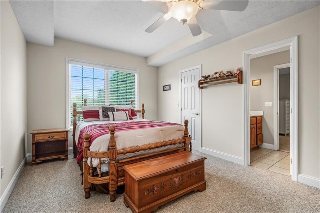 185 Pinkerton Road Wexford, PA 15090 - Photo 21 of 40 a bedroom with a bed and a chandelier