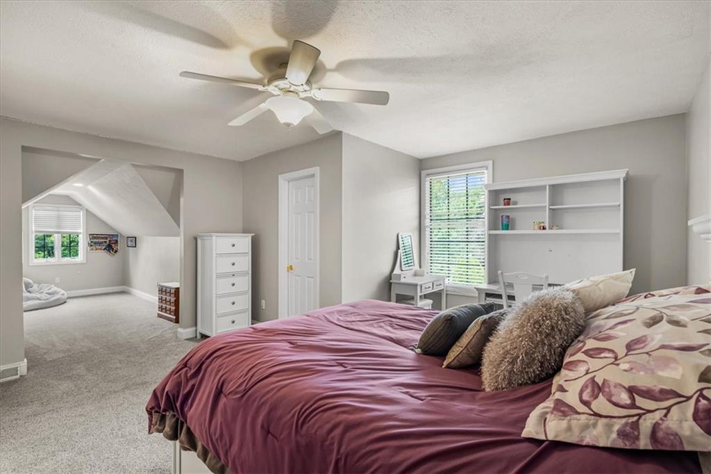 185 Pinkerton Road Wexford, PA 15090 - Photo 24 of 40 a bedroom with a large bed and a chandelier