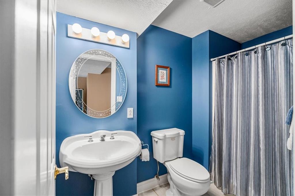 185 Pinkerton Road Wexford, PA 15090 - Photo 32 of 40 a bathroom with a sink a mirror a toilet and a mirror