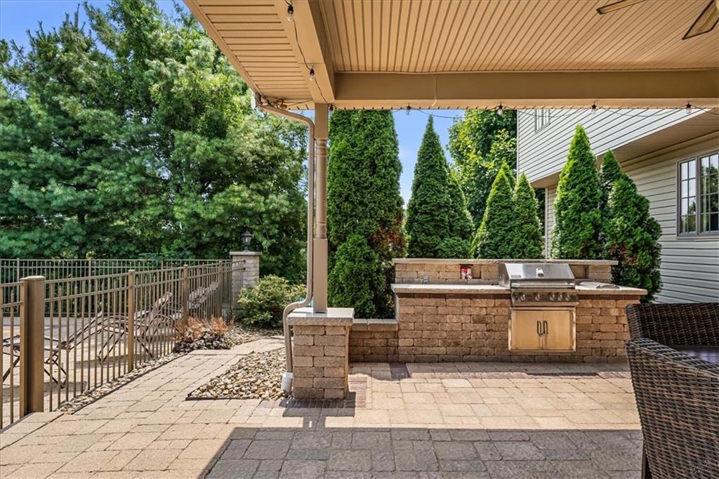 185 Pinkerton Road Wexford, PA 15090 - Photo 35 of 40 a view of a patio with table and chairs potted plants with wooden floor and fence