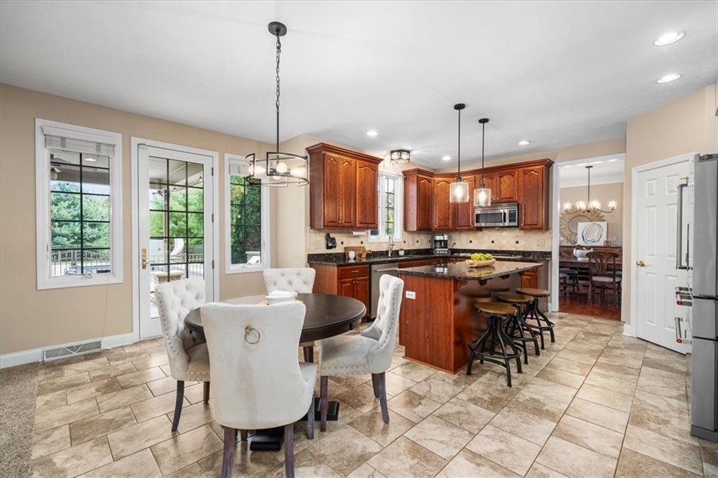 185 Pinkerton Road Wexford, PA 15090 - Photo 10 of 40 a dining table chairs and a kitchen view