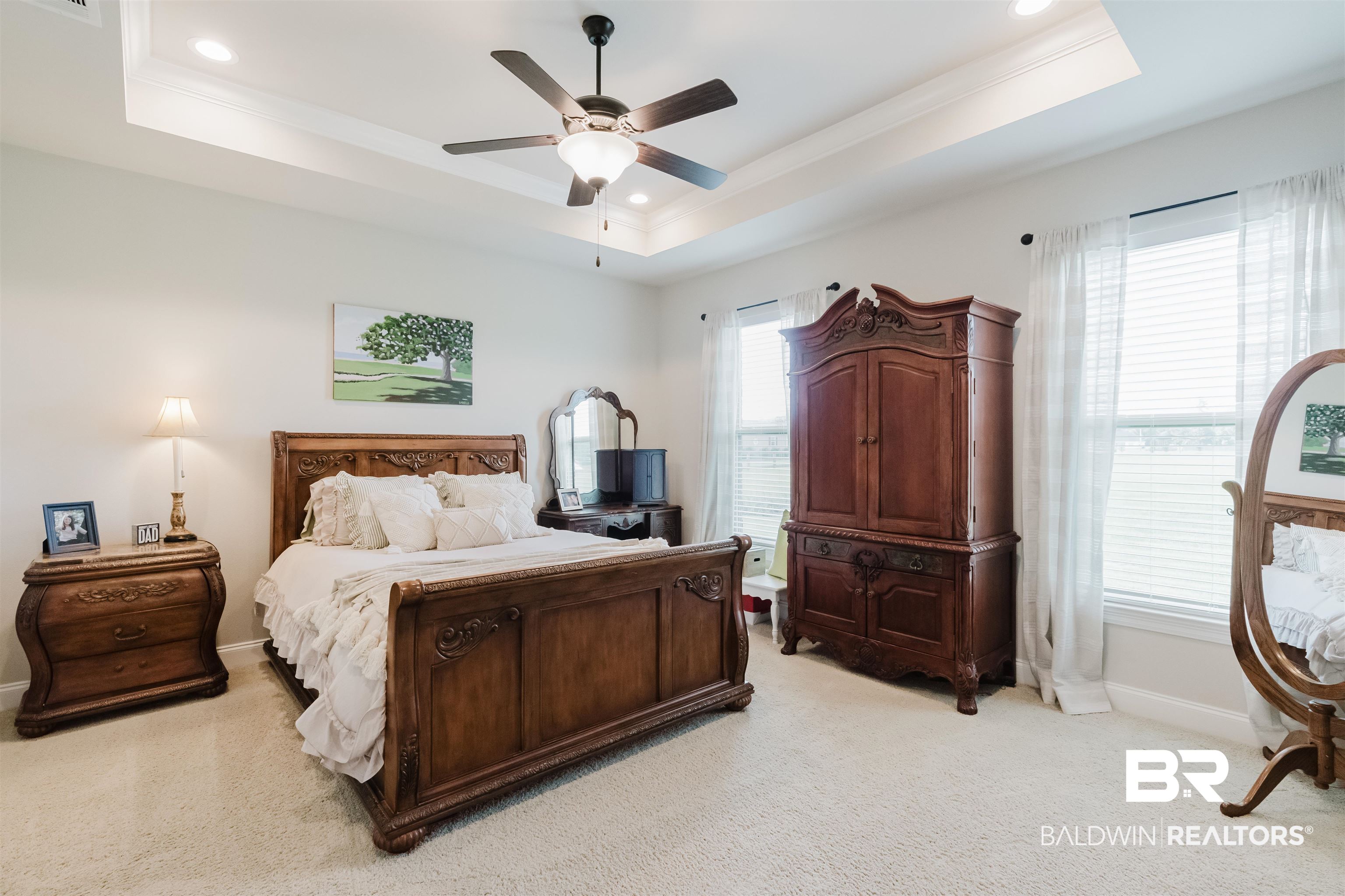 12128 Red Barn Road Fairhope, AL 36532 - Photo 15 of 47 Bedroom featuring a tray ceiling, light carpet, crown molding, baseboards, and recessed lighting