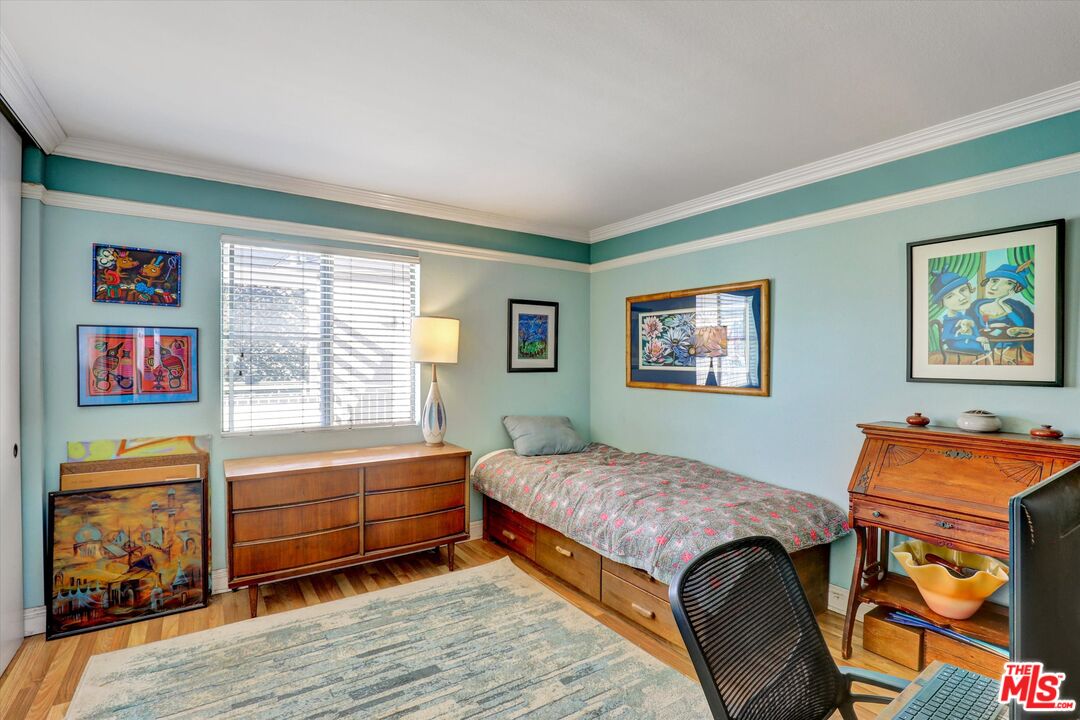 645 Chestnut Avenue, Unit 316 Long Beach, CA 90802 - Photo 12 of 24 a bedroom with a bed and wooden floor