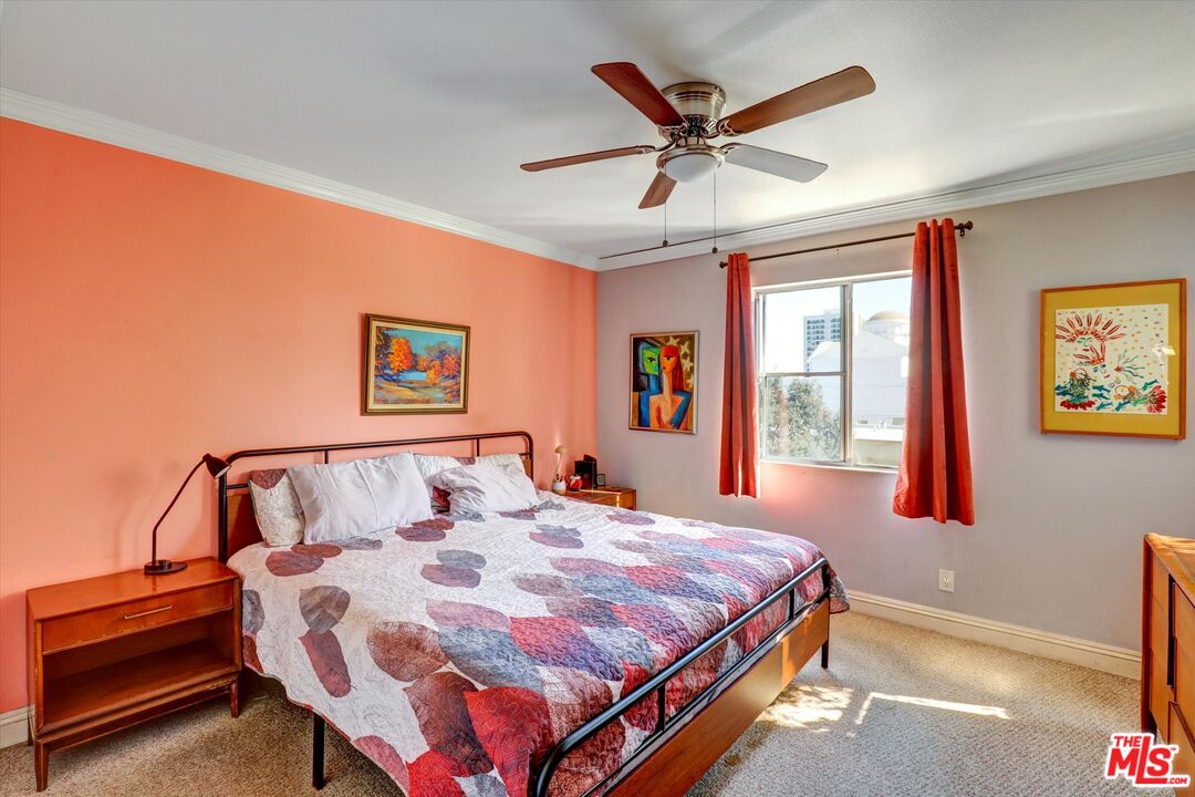 645 Chestnut Avenue, Unit 316 Long Beach, CA 90802 - Photo 17 of 24 a bedroom with a bed and a chandelier