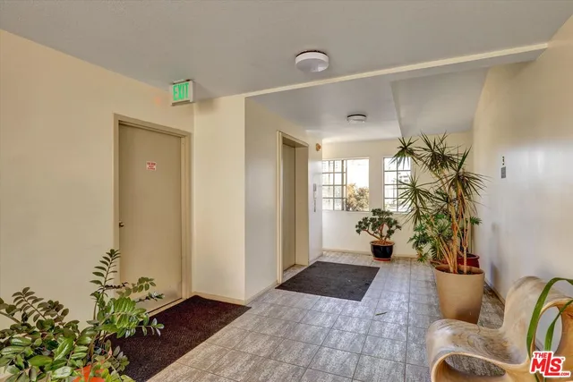 a view of a porch with furniture and a potted plant