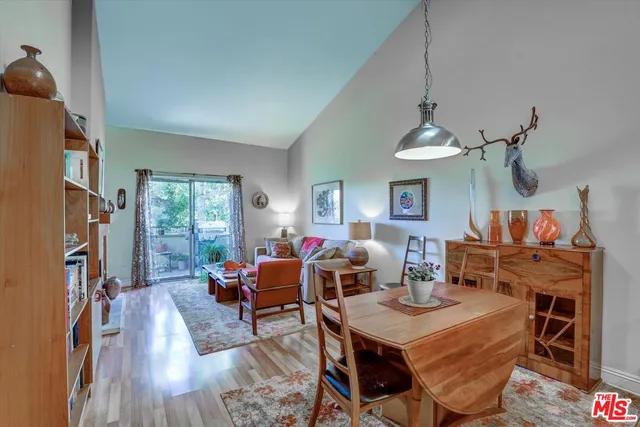 a view of a dining room with furniture a chandelier and wooden floor